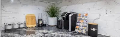 a kitchen with a counter with aasteryasteryasteryasteryasteryasteryasteryasteryastery at Lovely Ranch House in Windsor, 10 mins to Hartford Connecticut in Windsor