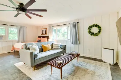 a living room with a couch and a ceiling fan at Modern Studio Less Than 13 Mi to Saratoga Racetrack! in Ballston Spa
