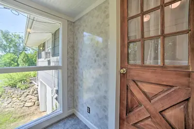 a wooden door in a room with a window at Modern Studio Less Than 13 Mi to Saratoga Racetrack! in Ballston Spa