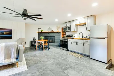 a kitchen with a white refrigerator and a table at Modern Studio Less Than 13 Mi to Saratoga Racetrack! in Ballston Spa