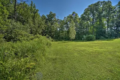 a field of grass with trees in the background at Modern Studio Less Than 13 Mi to Saratoga Racetrack! in Ballston Spa