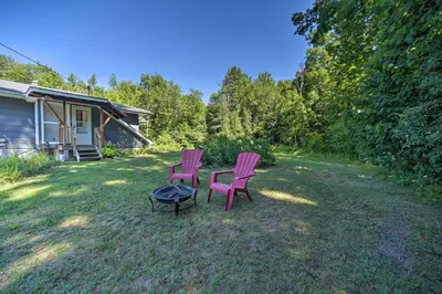 two pink chairs and a table in a yard at Modern Studio Less Than 13 Mi to Saratoga Racetrack! in Ballston Spa