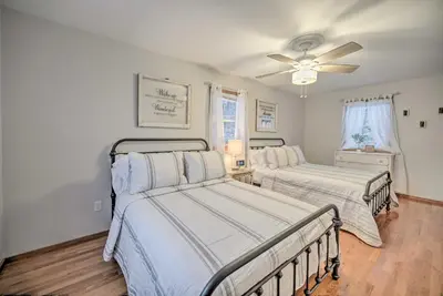 a bedroom with two beds and a ceiling fan at Lake Luzerne Home with Fire Pit on Hudson River in Lake Luzerne