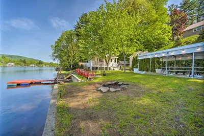a house with a fire pit next to a lake at Lake Luzerne Home with Fire Pit on Hudson River in Lake Luzerne
