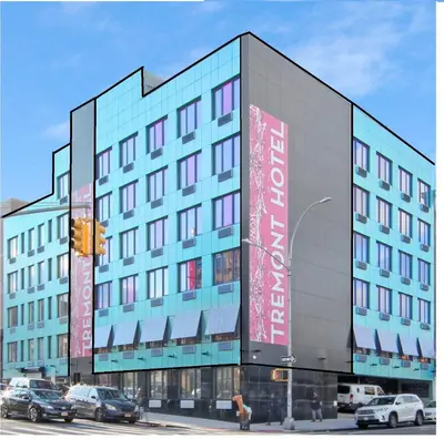 a large building with a sign on the side of it at Hotel TREMONT Bronx Yankee Stadium in Bronx