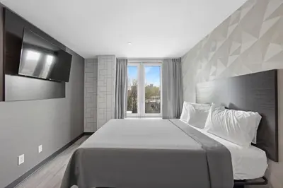 a bedroom with a large bed and a window at Hotel 365 Bronx - Yankee Stadium in Bronx