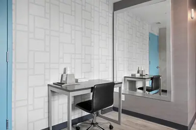 an office with a desk and a chair and a mirror at Hotel 365 Bronx - Yankee Stadium in Bronx