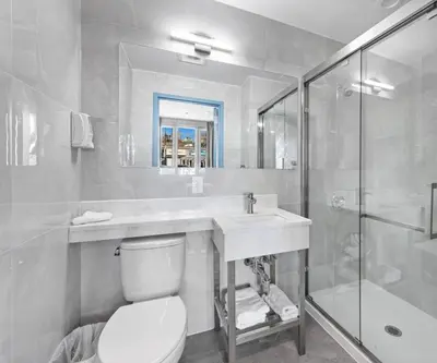 a bathroom with a toilet and a sink and a shower at Hotel 365 Bronx - Yankee Stadium in Bronx