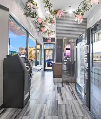 a store lobby with a cash register and flowers on the ceilings at Hotel 365 Bronx - Yankee Stadium in Bronx