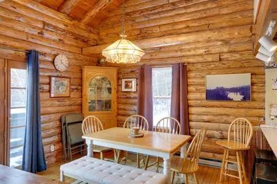 a dining room with a table and chairs at Pet-Friendly New York Cabin with Hot Tub and Game Room in Maplecrest