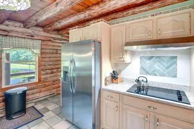 a kitchen with a stainless steel refrigerator at Pet-Friendly New York Cabin with Hot Tub and Game Room in Maplecrest