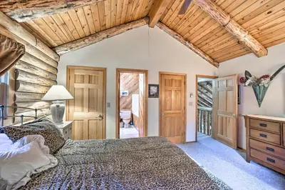 a bedroom with a bed and a wooden ceiling at Pet-Friendly New York Cabin with Hot Tub and Game Room in Maplecrest