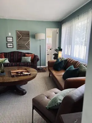 a living room with couches and a coffee table at The Springs Motel in New Ashford