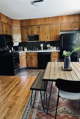 a kitchen with a wooden table with a potted plant on it at The Springs Motel in New Ashford