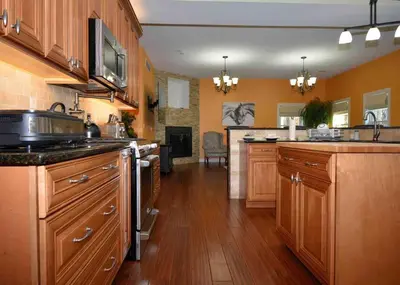 a large kitchen with wooden cabinets and a counter top at 9 Bedroom Saratoga Retreat, In-Ground Heated Pool, HotTub, Firepit, Gourmet Kitchen, Private Office in Saratoga Springs
