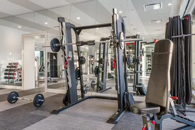 a gym with several tread machines and a chair at Global Luxury Suites Downtown White Plains in White Plains