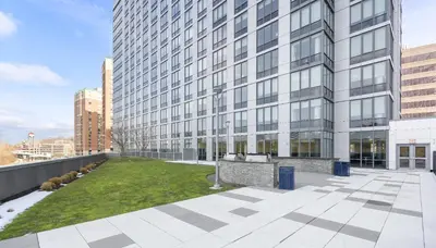 a large building with a lawn in front of it at Global Luxury Suites Downtown White Plains in White Plains