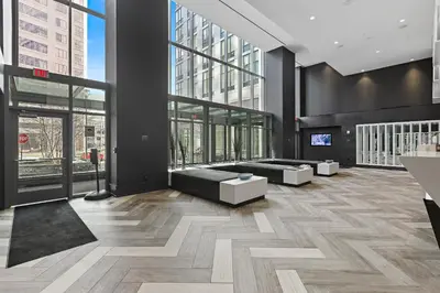 a lobby with couches and tables in a building at Global Luxury Suites Downtown White Plains in White Plains