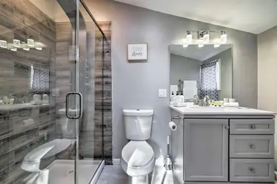 a bathroom with a shower and a toilet and a sink at Hot Tub, Fire Pit and Game Room Tobyhanna Home! in Tobyhanna