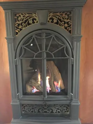 a fireplace is shown with flames in it at Raindrops On Roses Bed & Breakfast in Herkimer