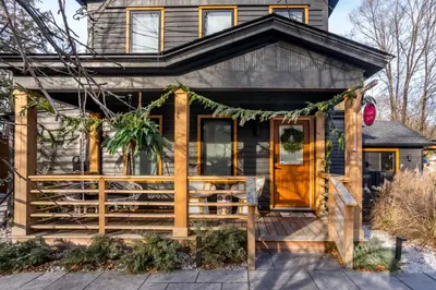 a house with a front porch with a christmas wreath at The Herwood Inn in Woodstock