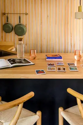 a wooden table with two chairs and a desk with pictures at The Herwood Inn in Woodstock