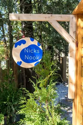 a sign that reads nicks norok hanging from a fence at The Herwood Inn in Woodstock