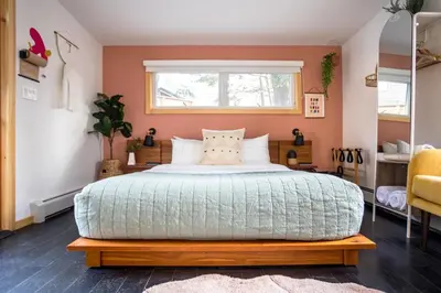 a bedroom with a large bed and a window at The Herwood Inn in Woodstock
