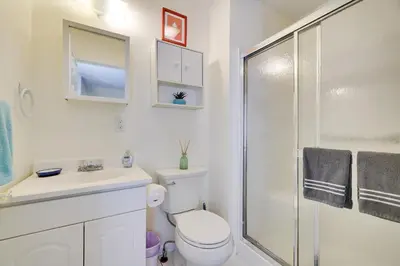 a bathroom with a shower and a toilet and a sink at Zen Den - Pocono LakeFront with Hot Tub ! in Pocono Summit