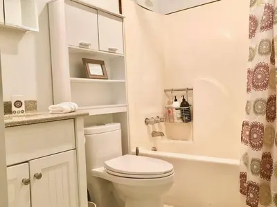 a white bathroom with a toilet and a shower at Beautiful Chalet with Hot Tub & Sauna in Poconos in Long Pond