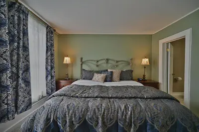 a bedroom with a large bed and a window at Tom Quick Inn in Milford