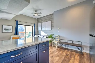 a kitchen with a counter top and a table at Steps to Ski Shuttle! Snow Mountain Village Condo in Dover