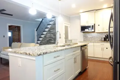a kitchen with white cabinets and a counter top at Best Home To Visit NYC+Hot Tub+EWR Airport+Free Parking in Hillside