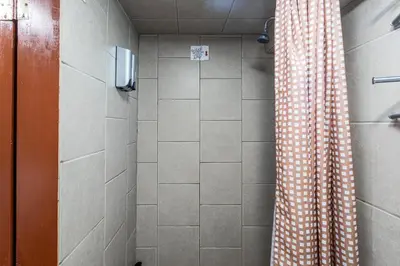 a shower with a checkered shower curtain in a bathroom at Best EWR Airport Studio-Hot Tub-Free Parking in Hillside