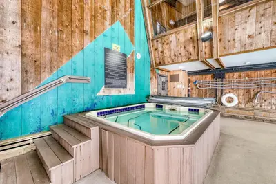 a hot tub in a room with wooden walls at Snow Country Home in Wilmington