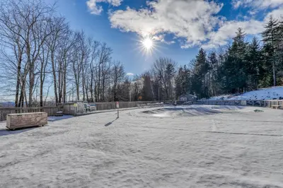 a skate park covered in snow with the sun in the sky at Snow Country Home in Wilmington