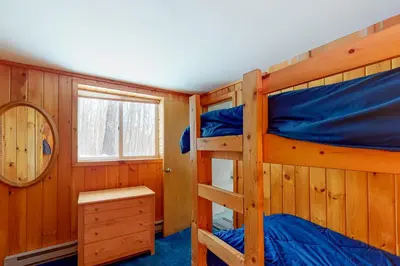 a bedroom with two bunk beds and a window at Snow Country Home in Wilmington