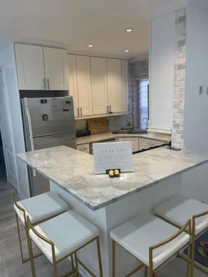 a kitchen with a counter with two stools and a sign on it at Renovated Jacuzzi Tub Home NYC-LGA-JFK Washer-Dryer in Kew Gardens