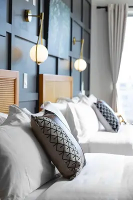 a group of pillows on a bed in a room at The Modernist Hotel in Long Island City
