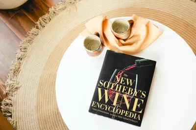 a book sitting on top of a table with a hat at The Modernist Hotel in Long Island City