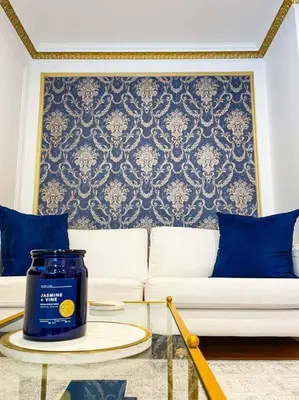 a living room with a white couch with blue pillows at Luxurious Room near LaGuardia & JFK in Corona