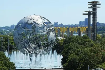 a large metal ball in front of a water fountain at Luxurious Room near LaGuardia & JFK in Corona