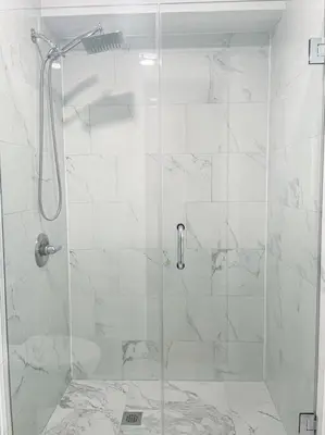 a shower with a glass door in a bathroom at Luxurious Room near LaGuardia & JFK in Corona