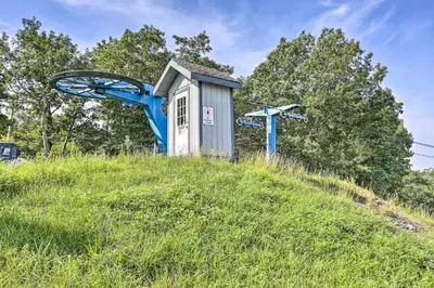 a smallshed on top of a grassy hill at Deck, Fire Pit and Pool Access at Poconos Retreat! in East Stroudsburg