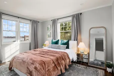 a bedroom with a large bed and a large mirror at Waterview house walking distance from Cove Beach-5 mins to downtown-only 40 min to NYC in Stamford