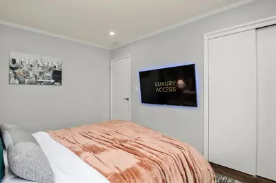 a bedroom with a bed and a tv on the wall at Waterview house walking distance from Cove Beach-5 mins to downtown-only 40 min to NYC in Stamford