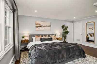 a bedroom with a large bed and a mirror at Waterview house walking distance from Cove Beach-5 mins to downtown-only 40 min to NYC in Stamford