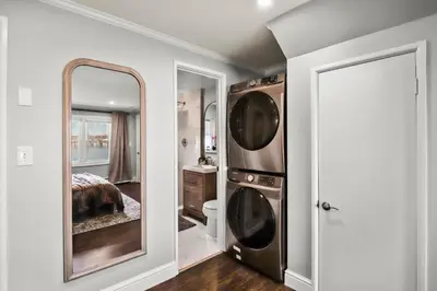 a bathroom with a mirror and a sink and a bed at Waterview house walking distance from Cove Beach-5 mins to downtown-only 40 min to NYC in Stamford