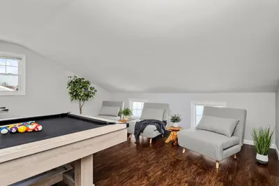 a living room with a pool table and chairs at Waterview house walking distance from Cove Beach-5 mins to downtown-only 40 min to NYC in Stamford