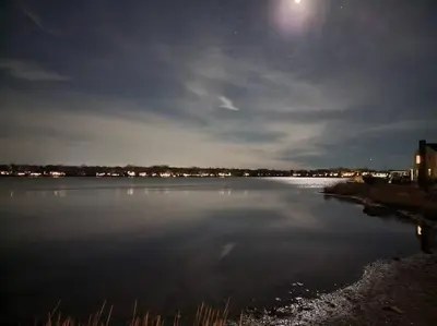a large body of water at night with the moon at Waterview house walking distance from Cove Beach-5 mins to downtown-only 40 min to NYC in Stamford